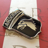 Metallic airborne badge on a red and white background