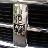 Chrome 101st Airborne Division Metal Auto Decal  on a vehicle grille with 'Airborne' logo reflected