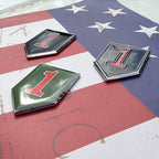 1st Infantry Division Metal Decal Set of 3 on an american flag facing to the right