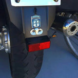 Close-up of a vehicle's rear with a red taillight and Airborne logo on a blue background.