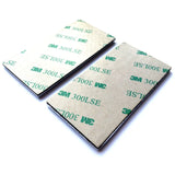 Two sheets of 3M tape with adhesive on a white background