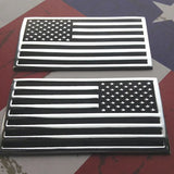 Two American flags with a metallic finish on a textured background