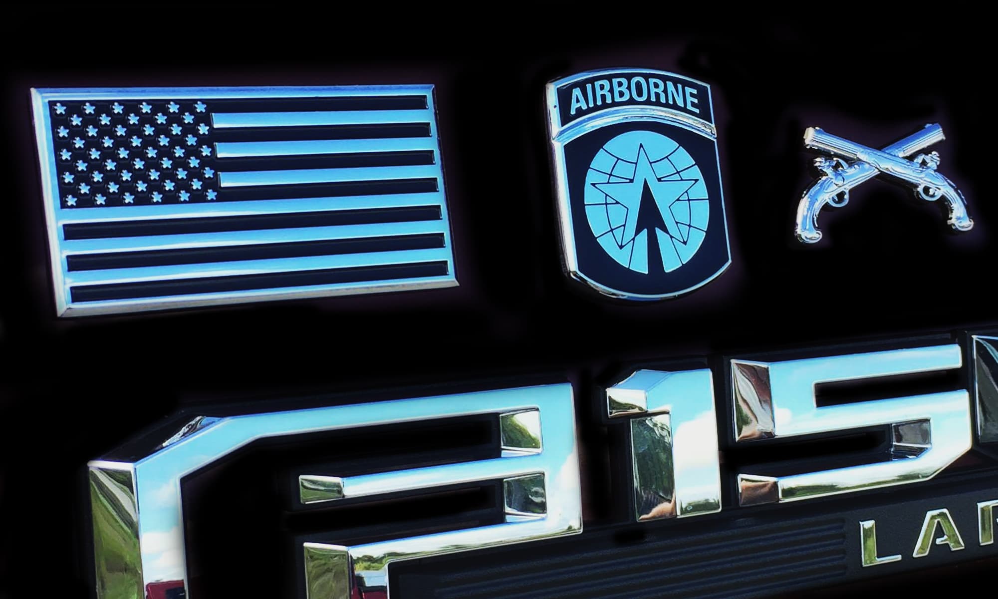 Emblems including an American flag, airborne badge, and a gun on a black background.