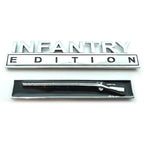 Chrome 'INFANTRY EDITION' emblem and rifle-shaped object on a white background