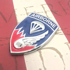 187th Infantry Regiment Airborne Metal Car Emblem Decal pointing to the left on a red and white background