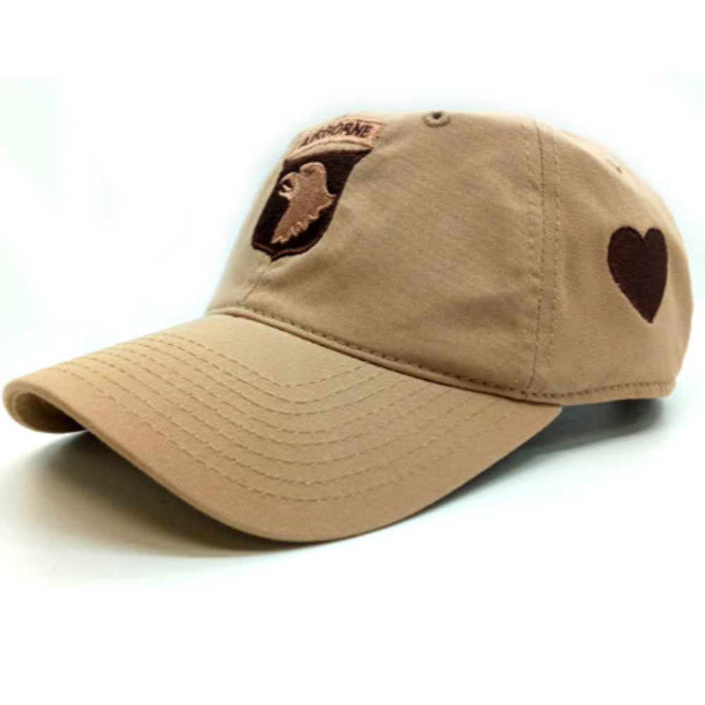 Beige cap with brown heart design on a white background