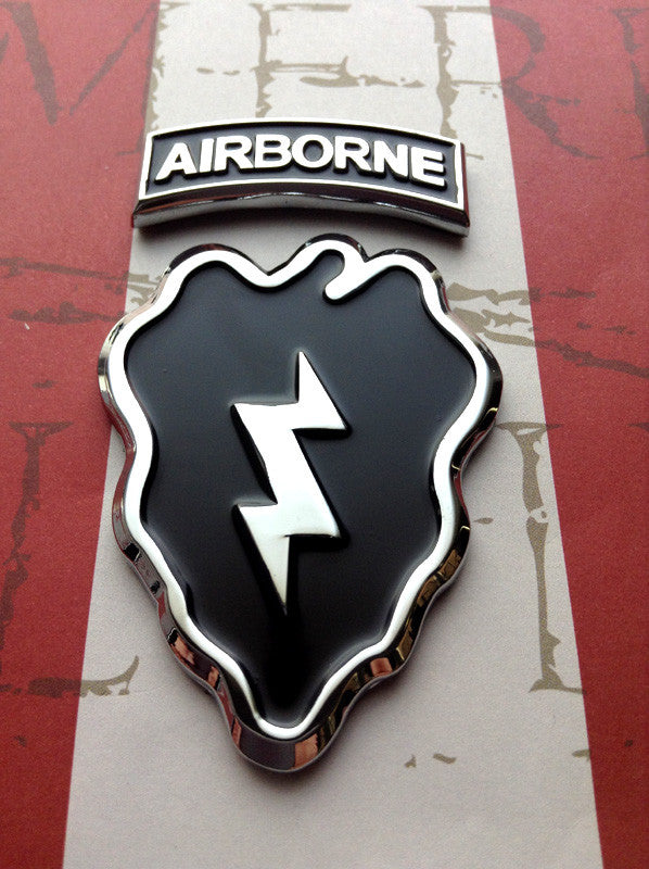 Two curved metallic tabs with the word 'AIRBORNE' embossed in capital letters, one larger and one smaller, placed on a map background.