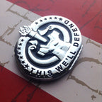 Army Drill Sergeant Badge This We'll Defend Metal Decal On Red Background at a Left Angle