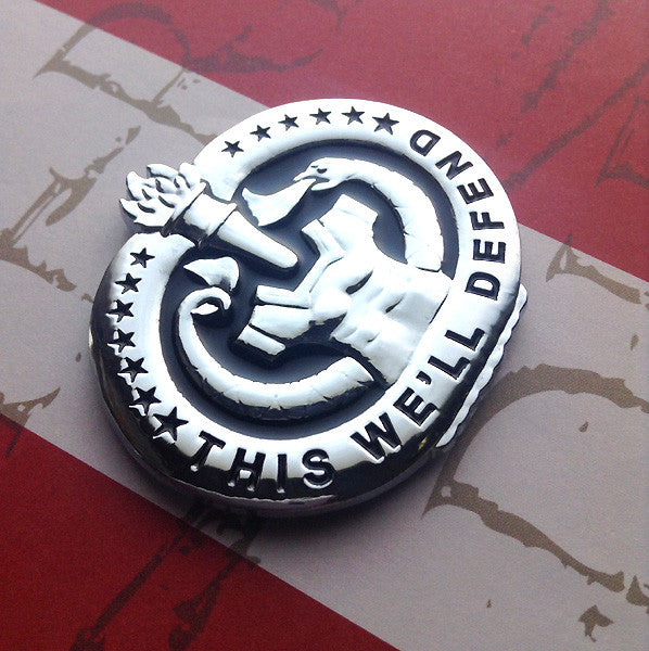Army Drill Sergeant Badge This We'll Defend Metal Decal On Red Background at a Left Angle