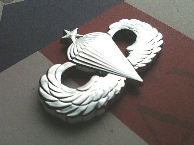 Chrome Senior Parachutist Badge Metal Decal Angled to the left on a Red, White, and Blue Background