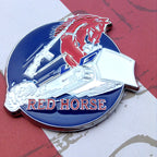 Decorative emblem with a red horse, rifle, and boot on a blue background, featuring the text 'Red Horse'.