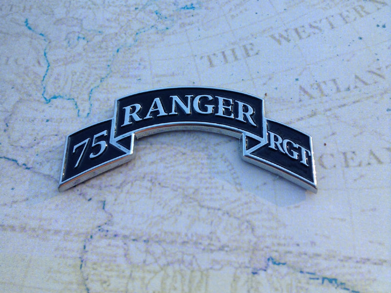 A black and silver scroll badge with the text '75 Ranger Regt' on a map background.