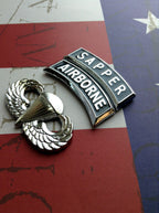Sapper Tab Chrome Emblem with airborne tab and jump wings badge on an American flag background