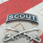 Scout tab with insignia on a red and grey background